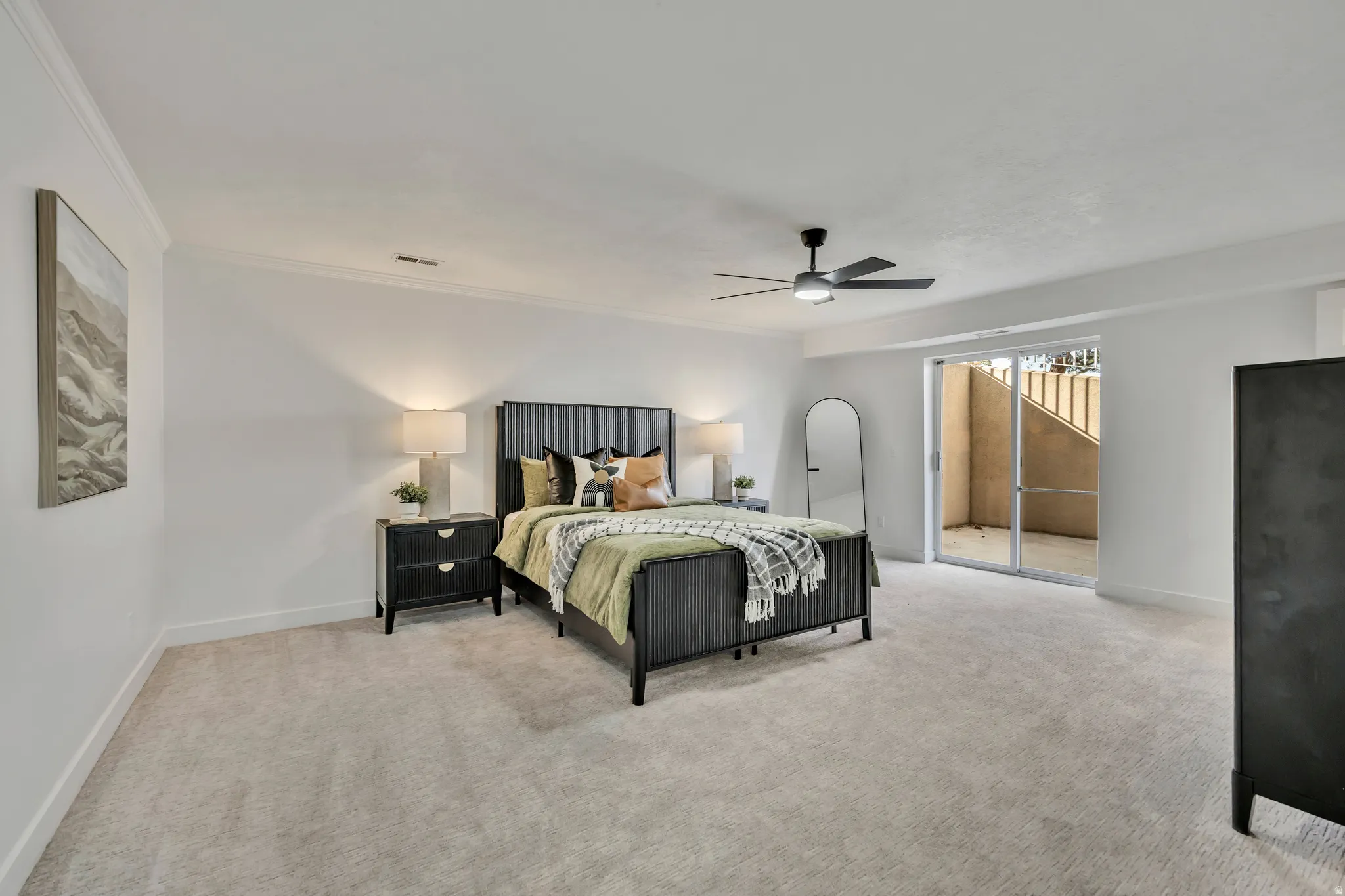 Bedroom featuring crown molding, light carpet, access to exterior, and a ceiling fan