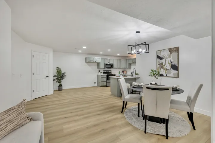 Dining room with light wood-style flooring and a chandelier
