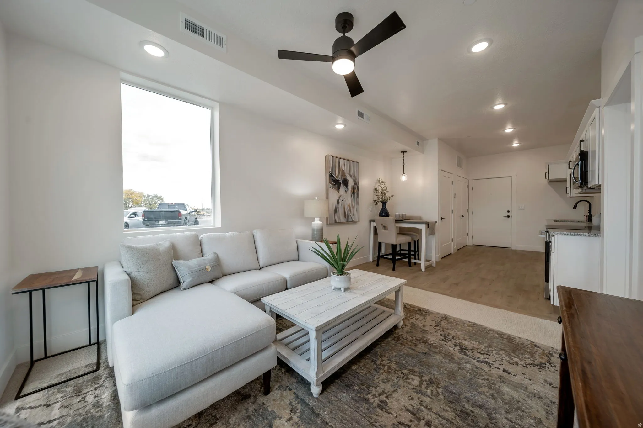 Living room featuring recessed lighting and a ceiling fan