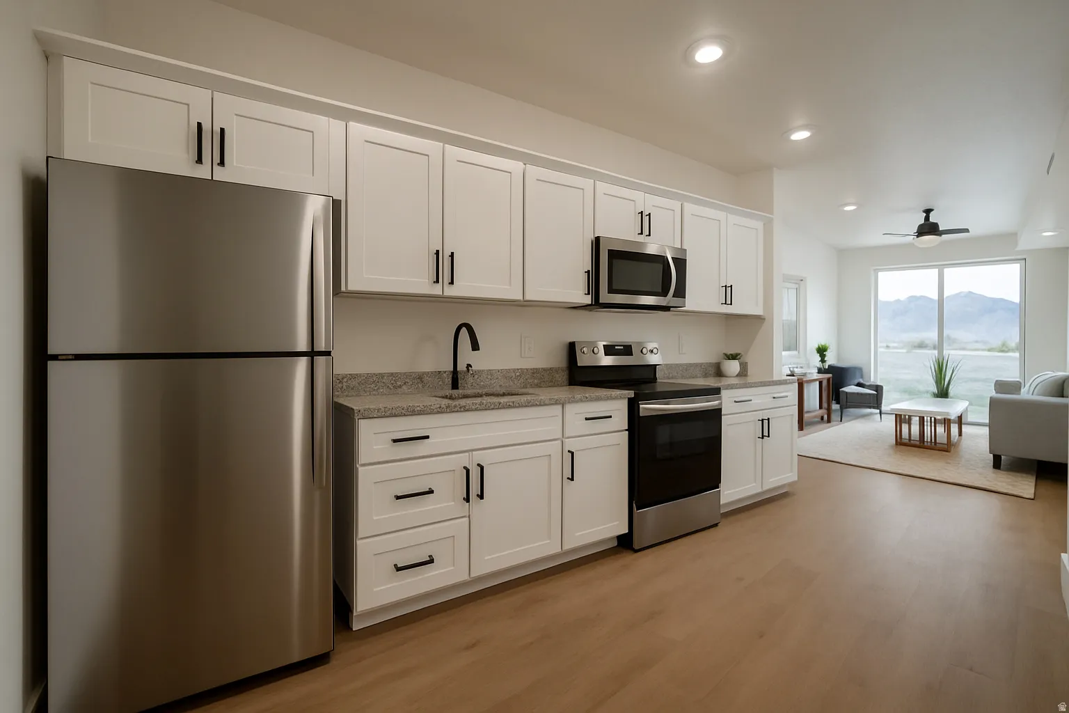 Kitchen featuring stainless steel appliances, white cabinets, a mountain view, light stone countertops, and ceiling fan
