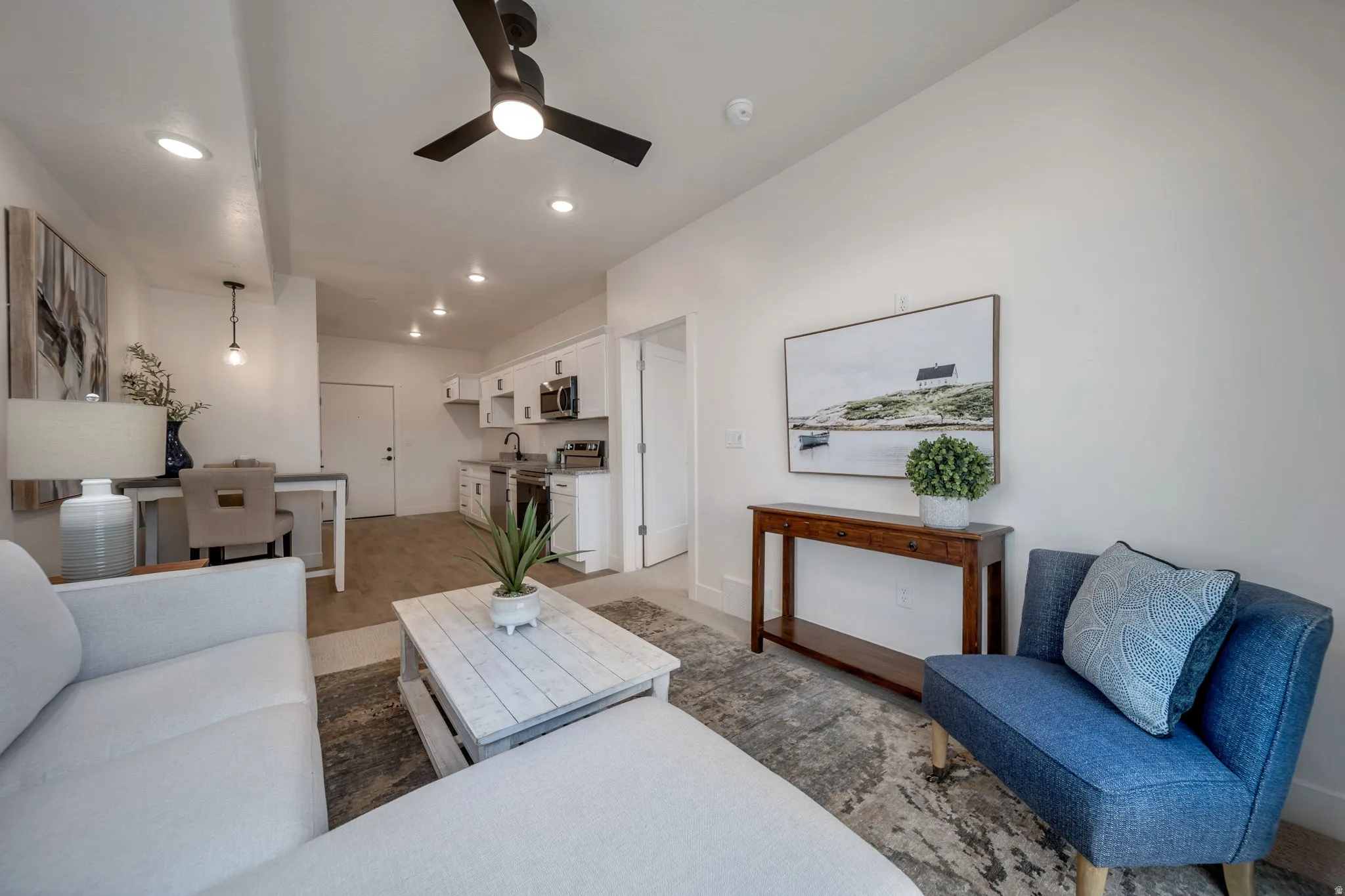 Living room featuring ceiling fan, recessed lighting, and light wood-style floors