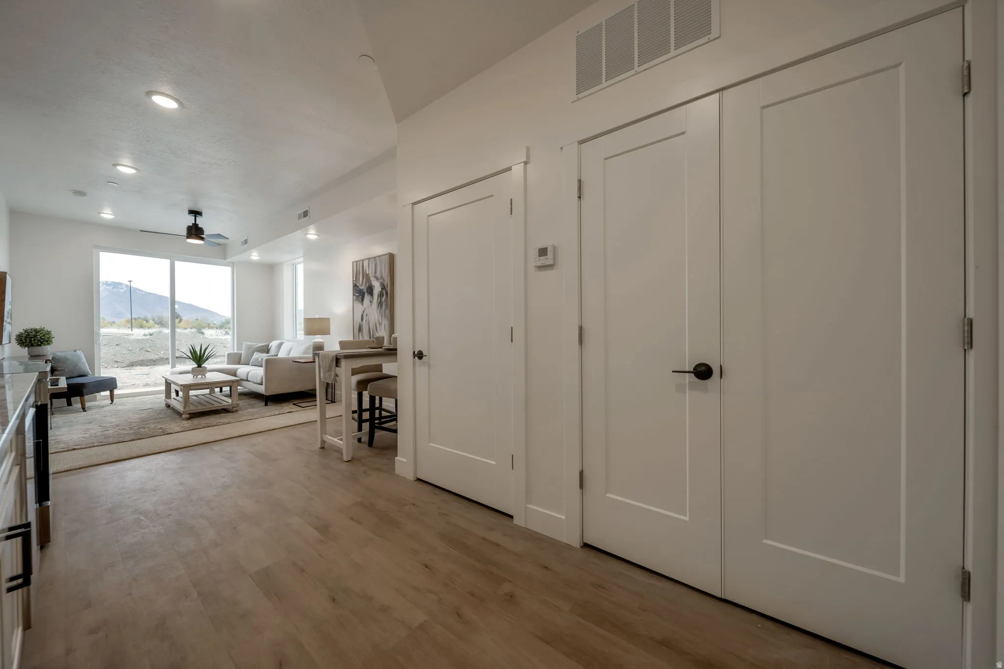 Foyer featuring a mountain view, light wood-type flooring, ceiling fan, and recessed lighting