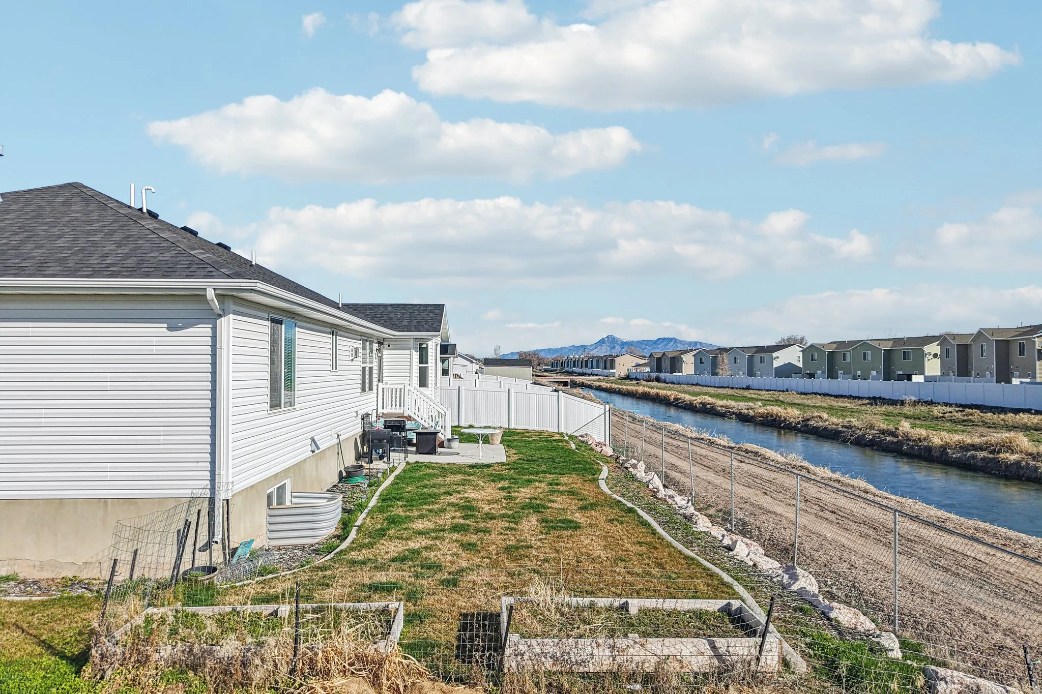 Water view featuring a fenced backyard and nearby suburban area
