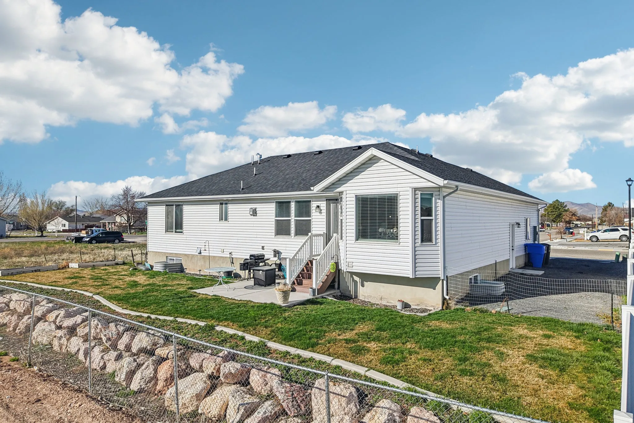 Back of house featuring a patio, entry steps, and roof with shingles