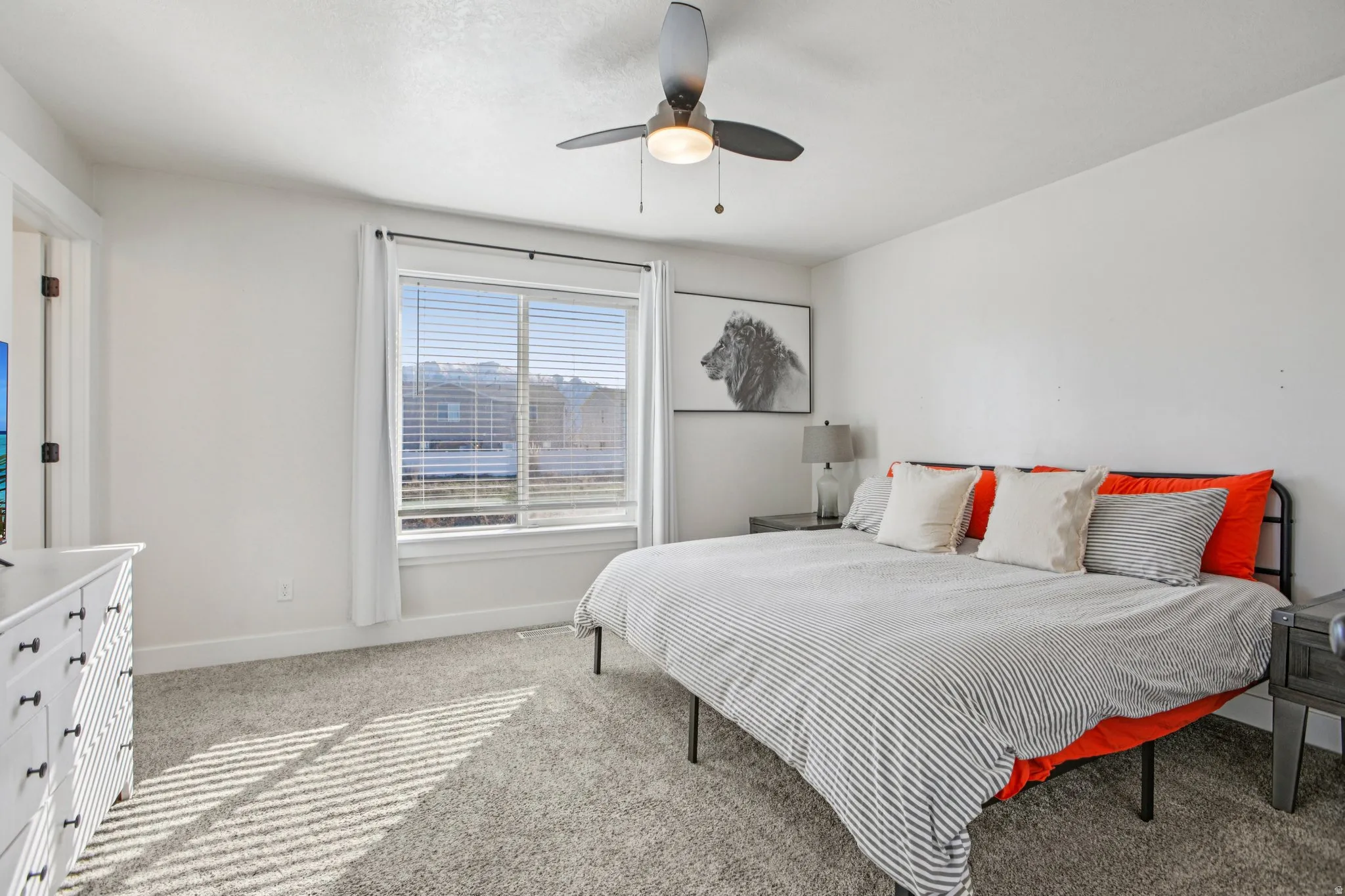 Bedroom featuring light carpet and a ceiling fan