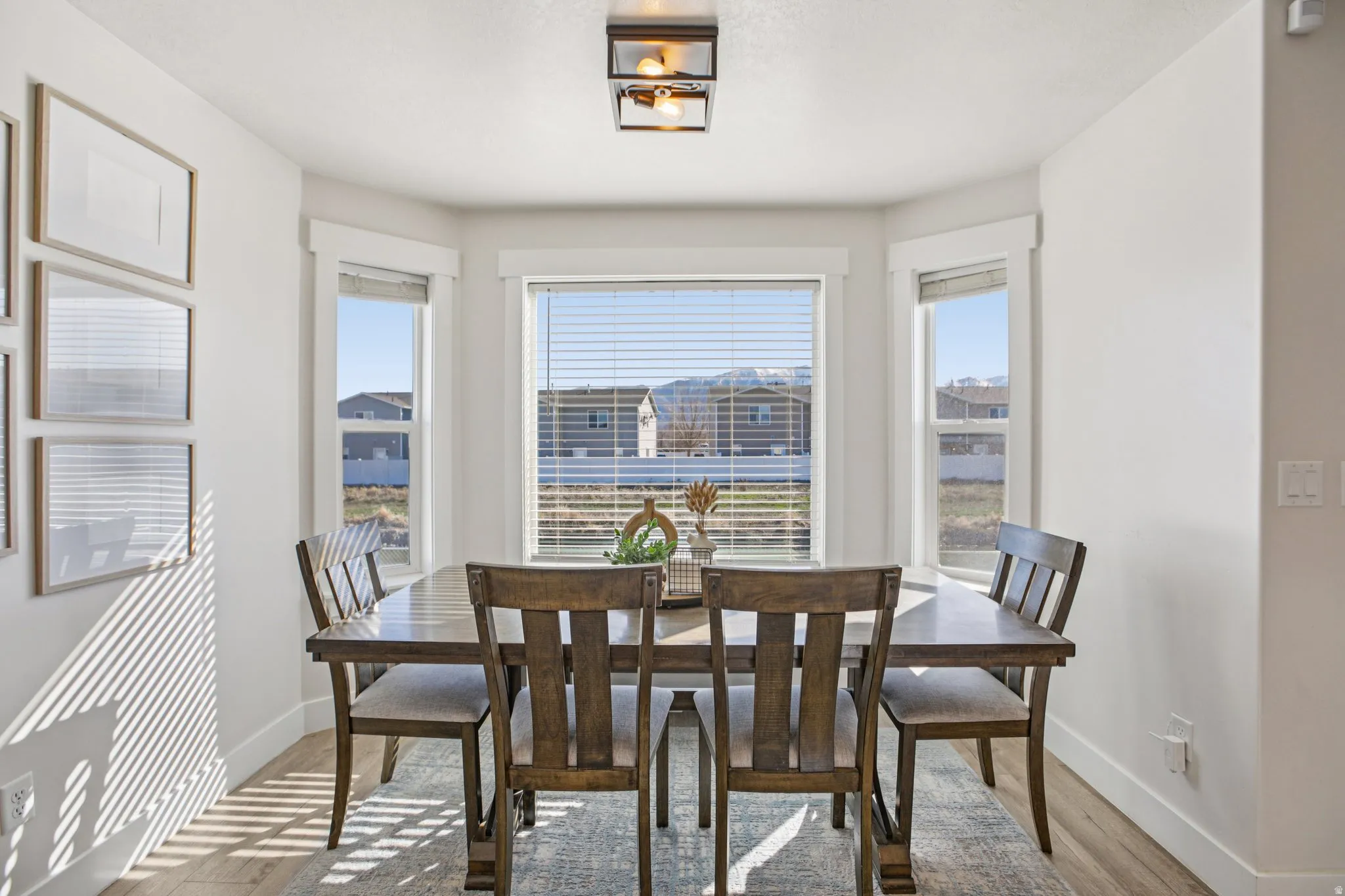 Dining room featuring light wood finished floors and baseboards