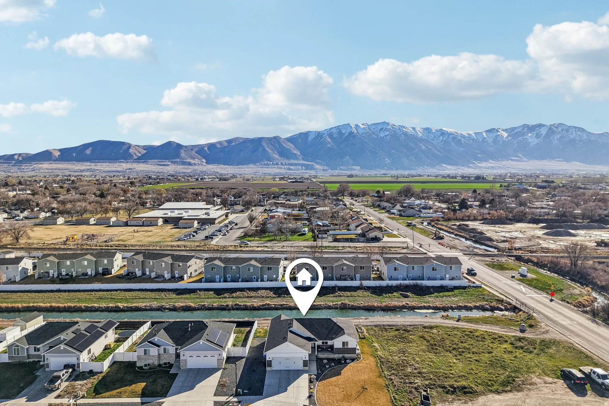 Aerial perspective of suburban area with a mountain backdrop