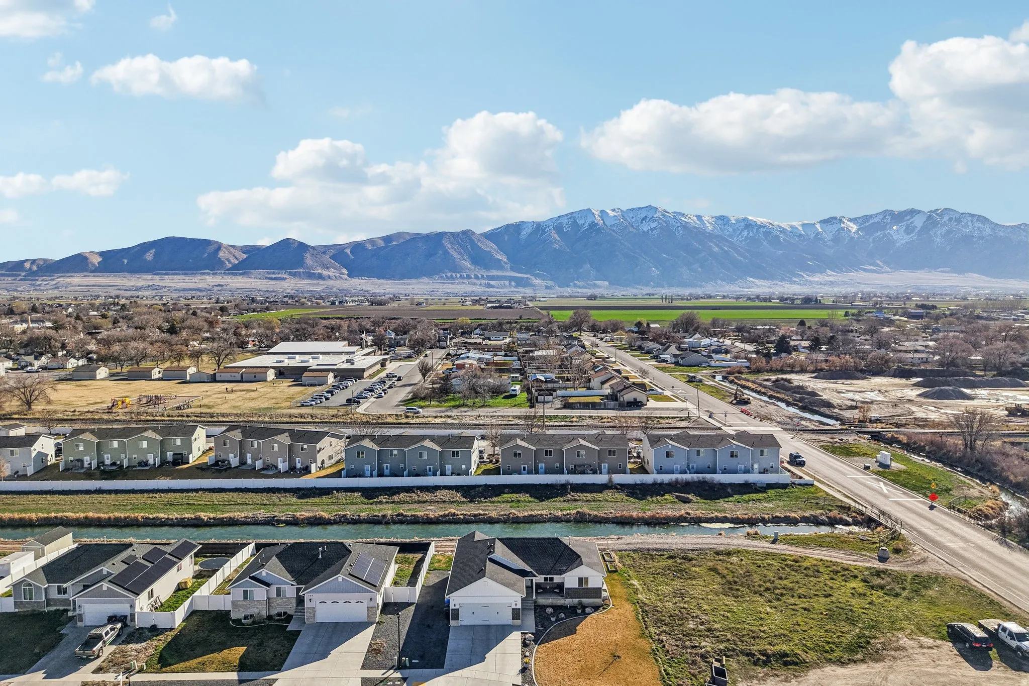 Aerial perspective of suburban area featuring a mountainous background