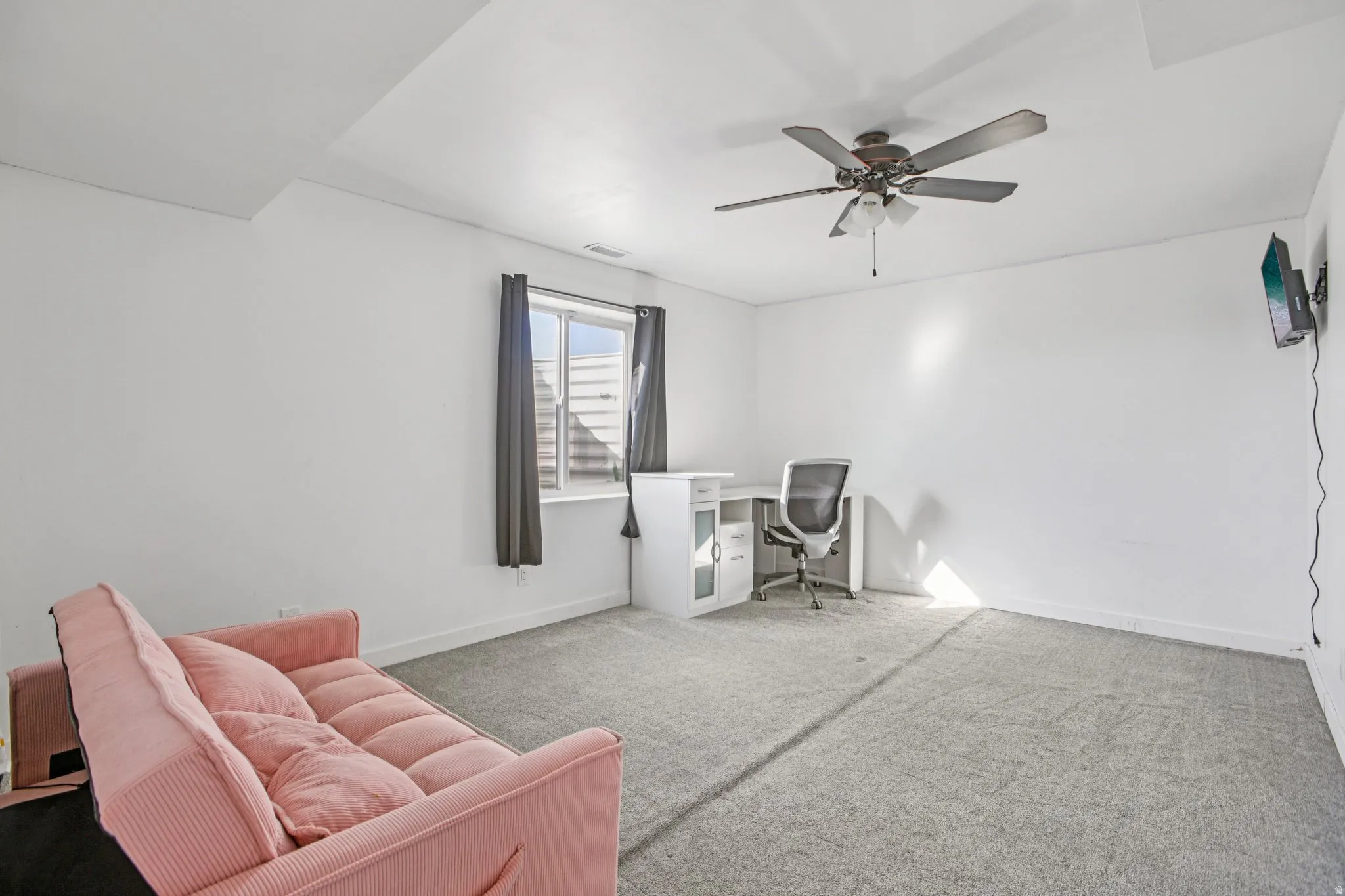Office space with carpet flooring and a ceiling fan