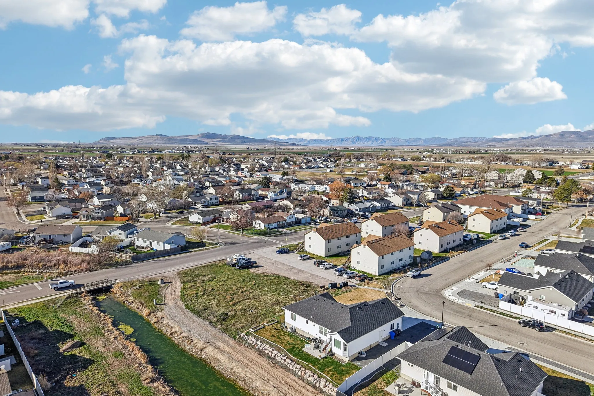Aerial perspective of suburban area featuring a mountain backdrop
