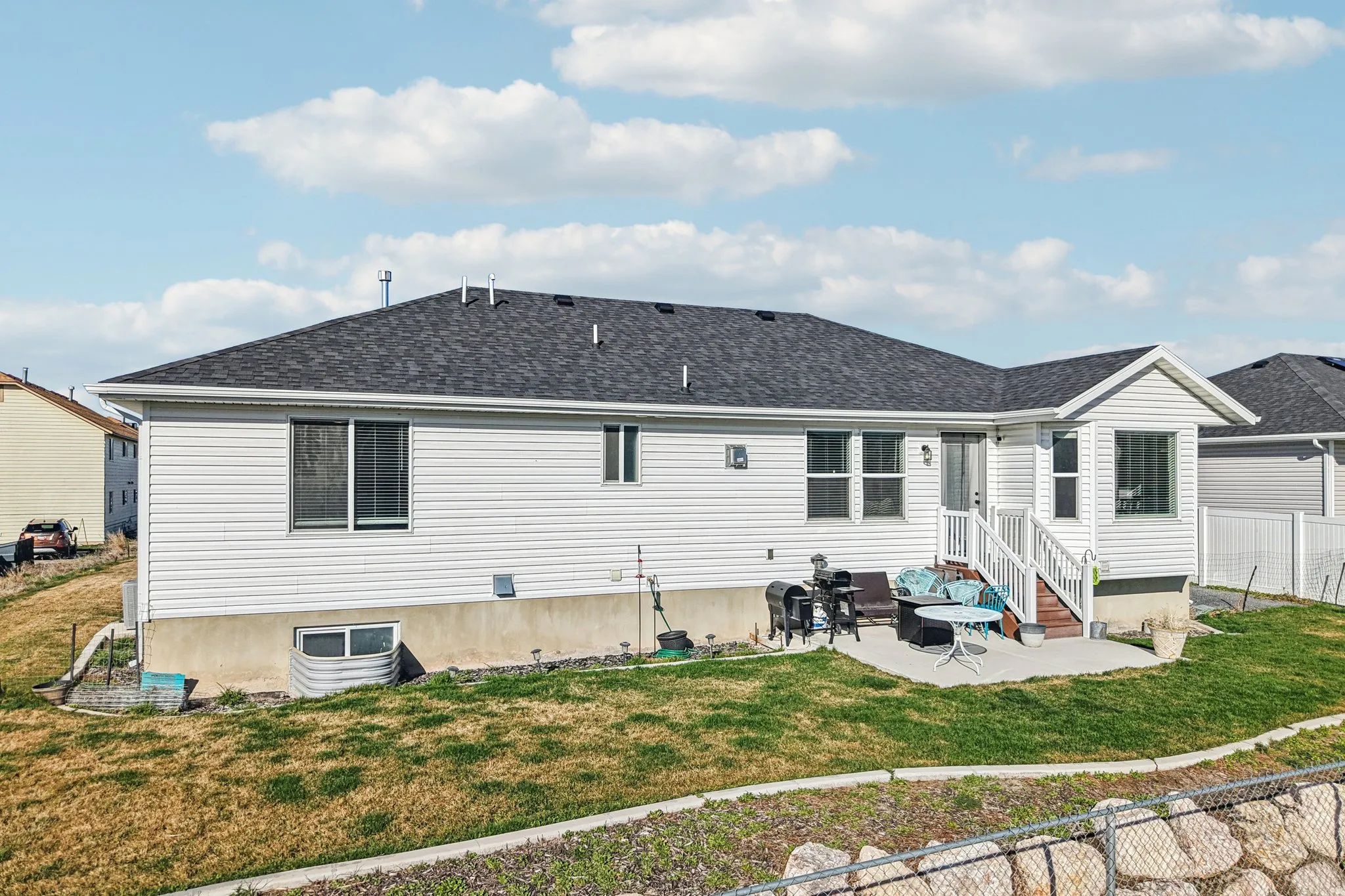 Rear view of house with a patio area and roof with shingles