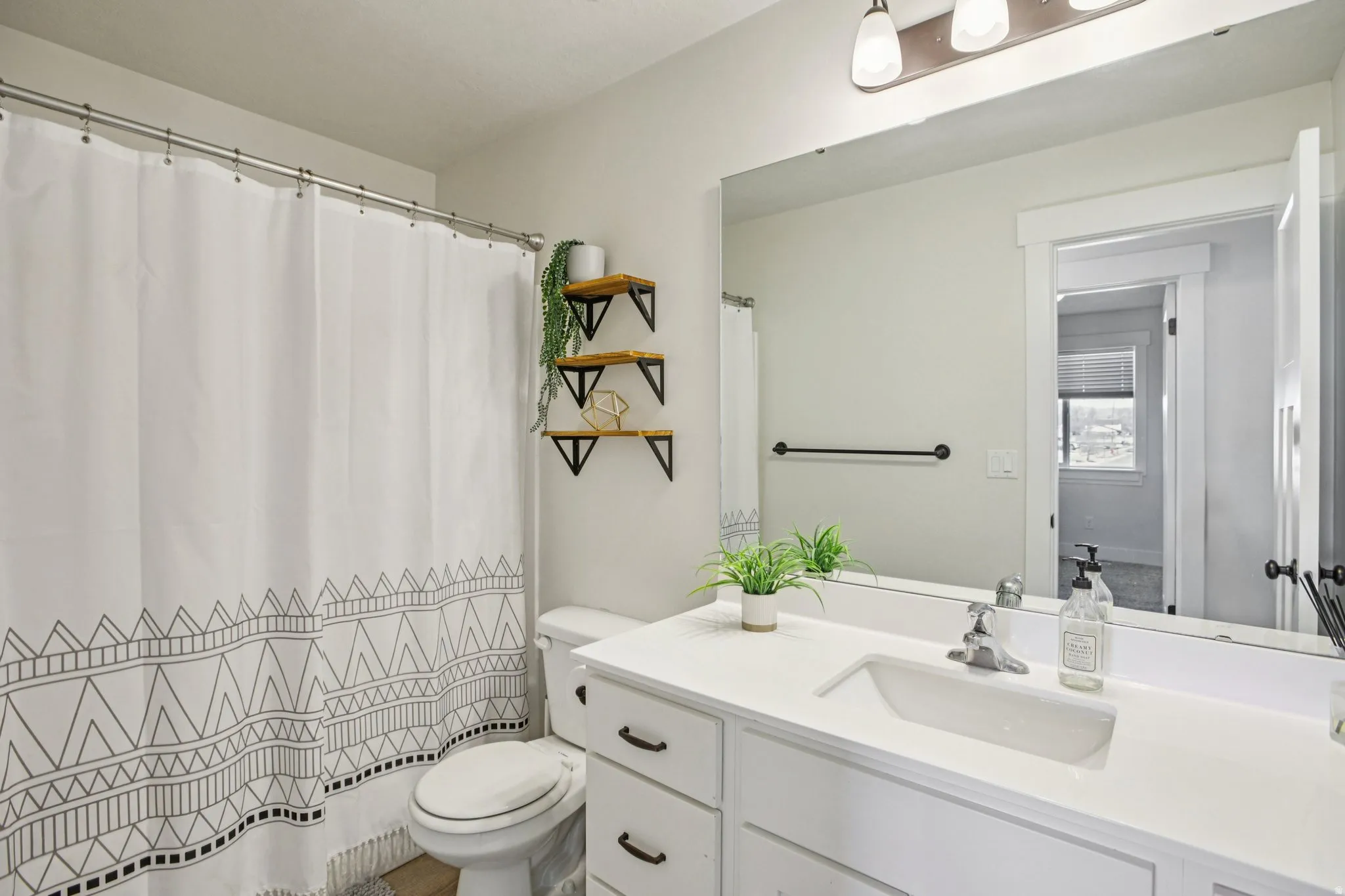 Bathroom with vanity and a shower with shower curtain