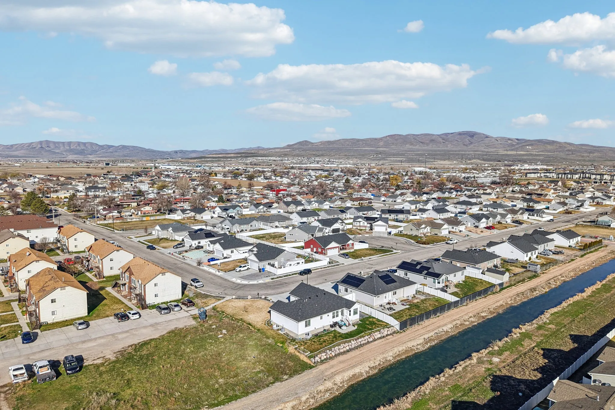 Aerial perspective of suburban area with a mountainous background