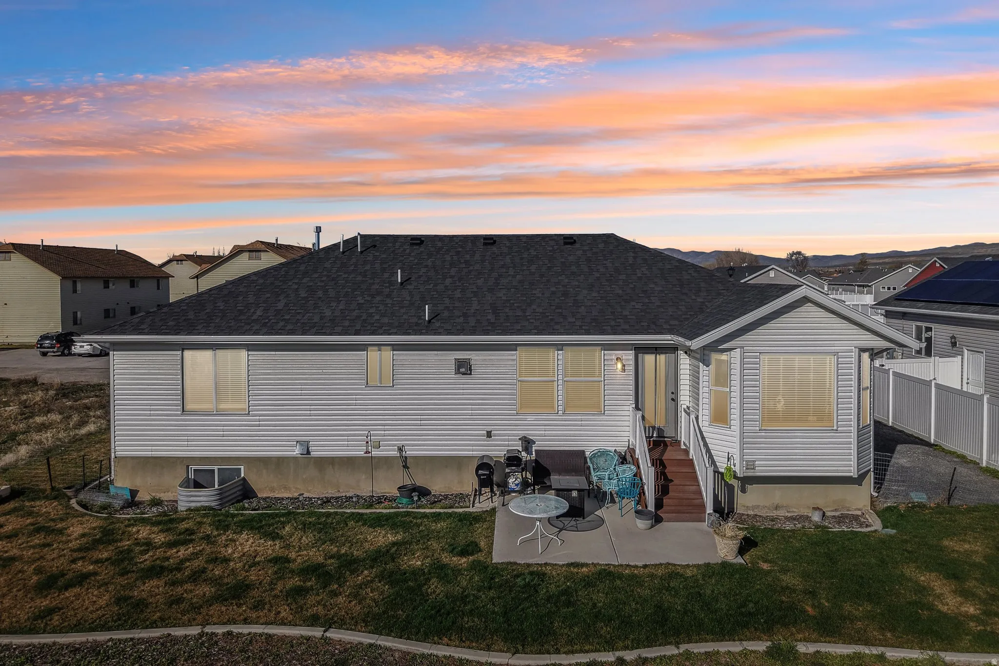 Back of house with a patio area, roof with shingles, and entry steps