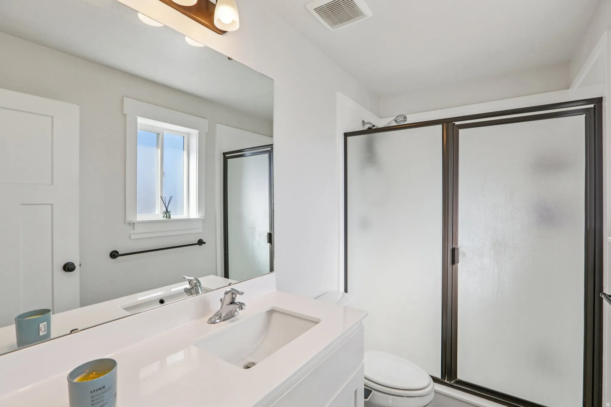 Bathroom featuring vanity and a shower stall