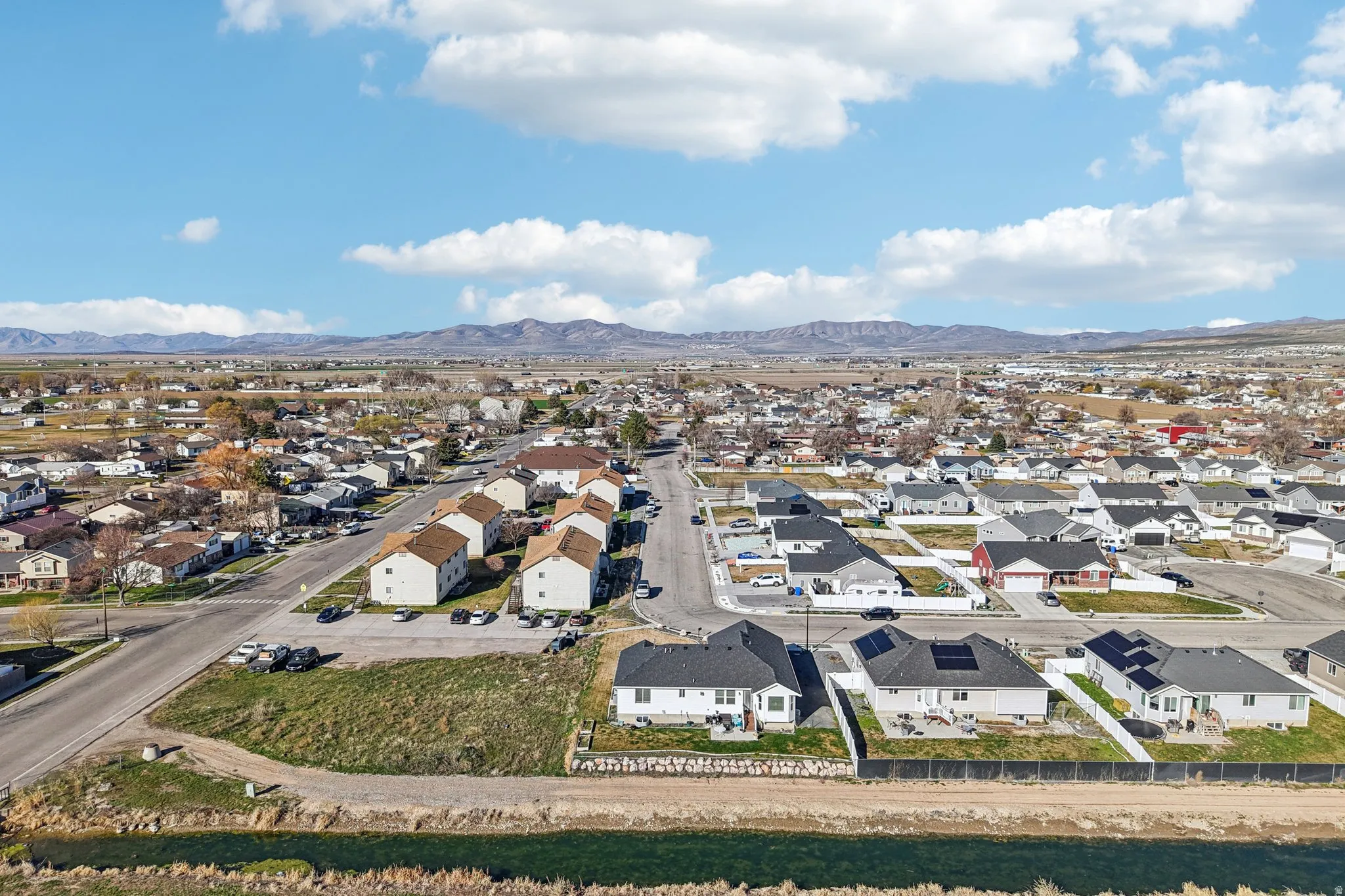 Aerial perspective of suburban area with a mountain backdrop