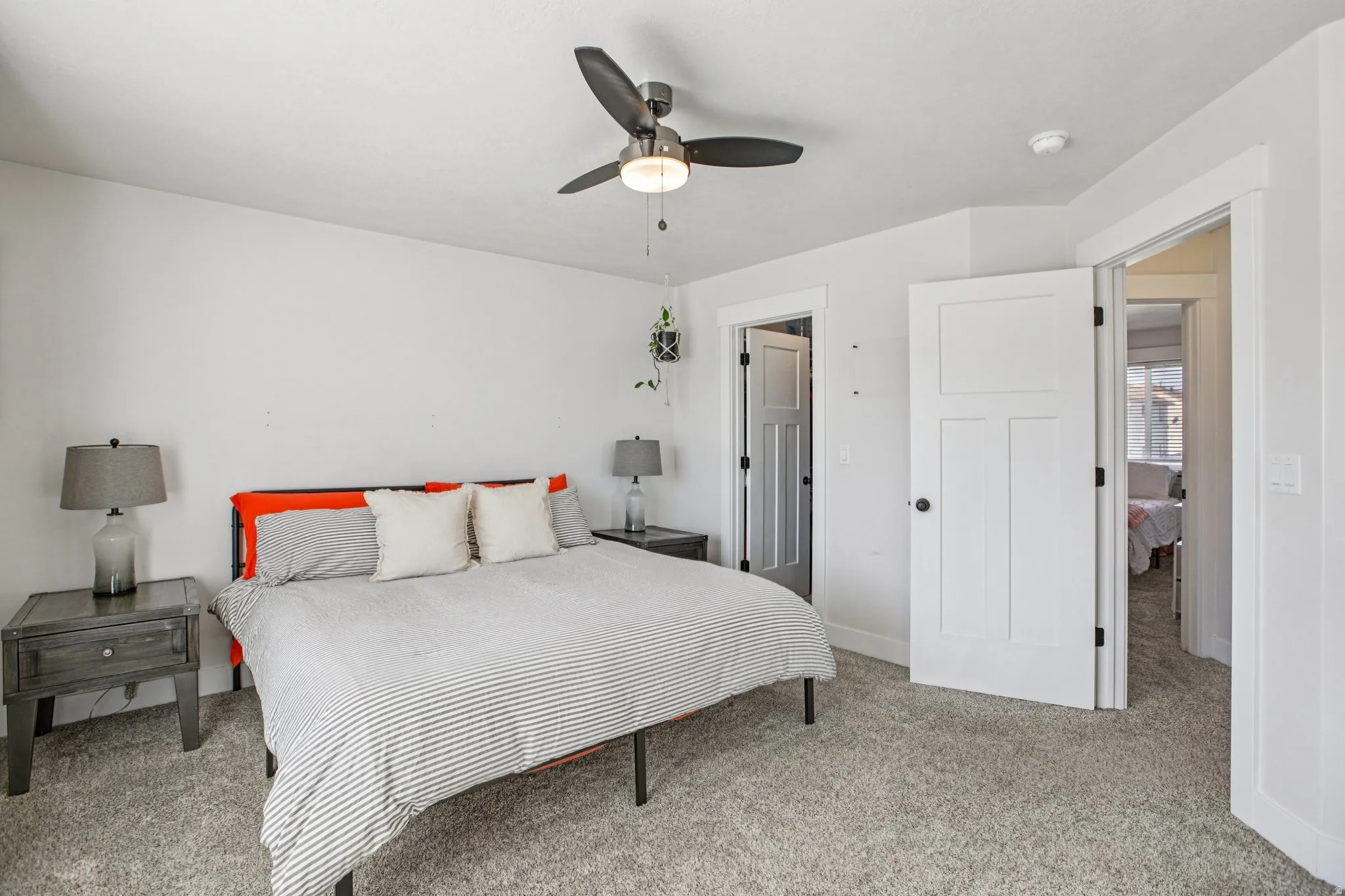 Bedroom featuring light colored carpet and a ceiling fan