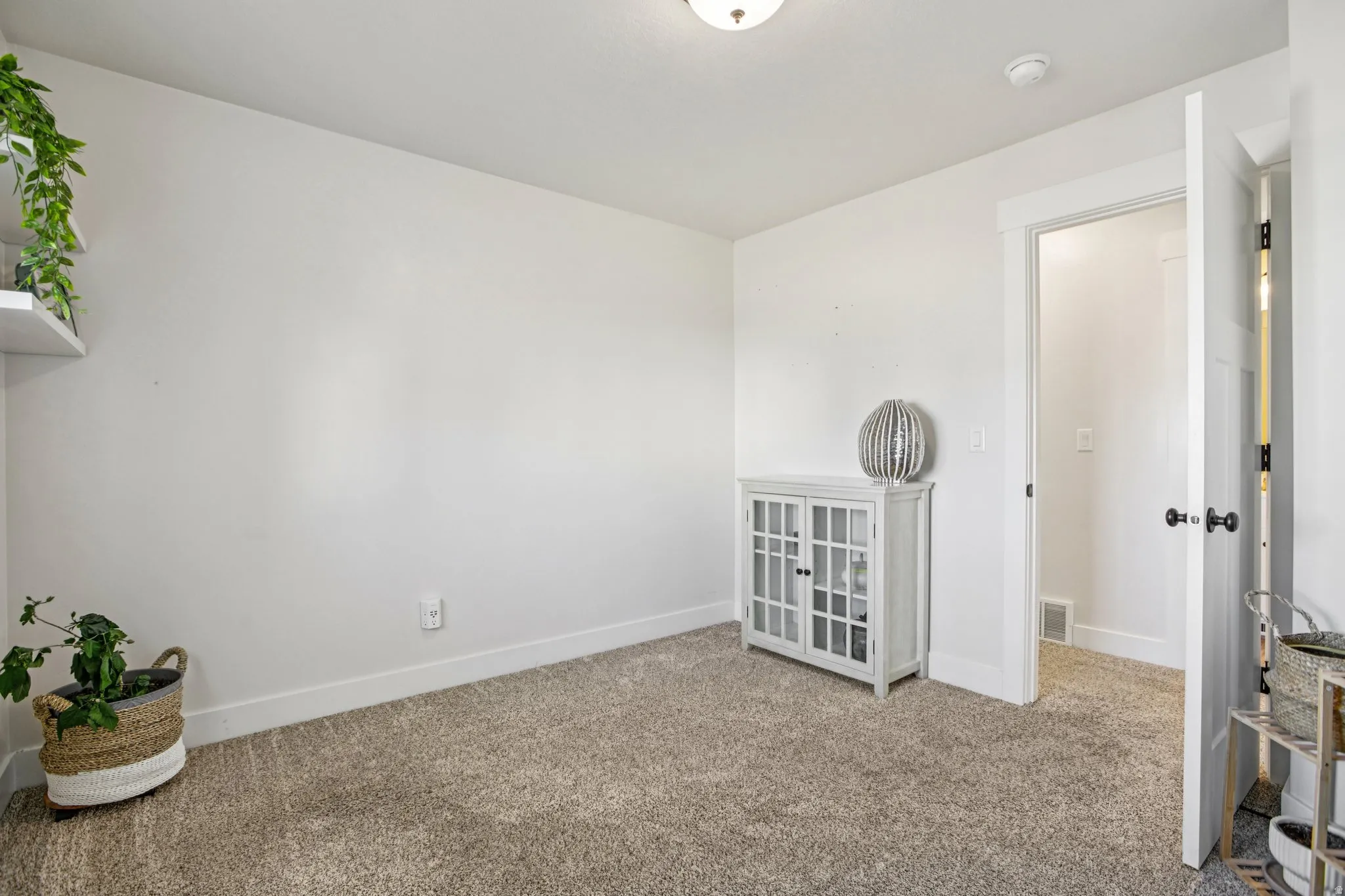Empty room featuring baseboards and carpet flooring