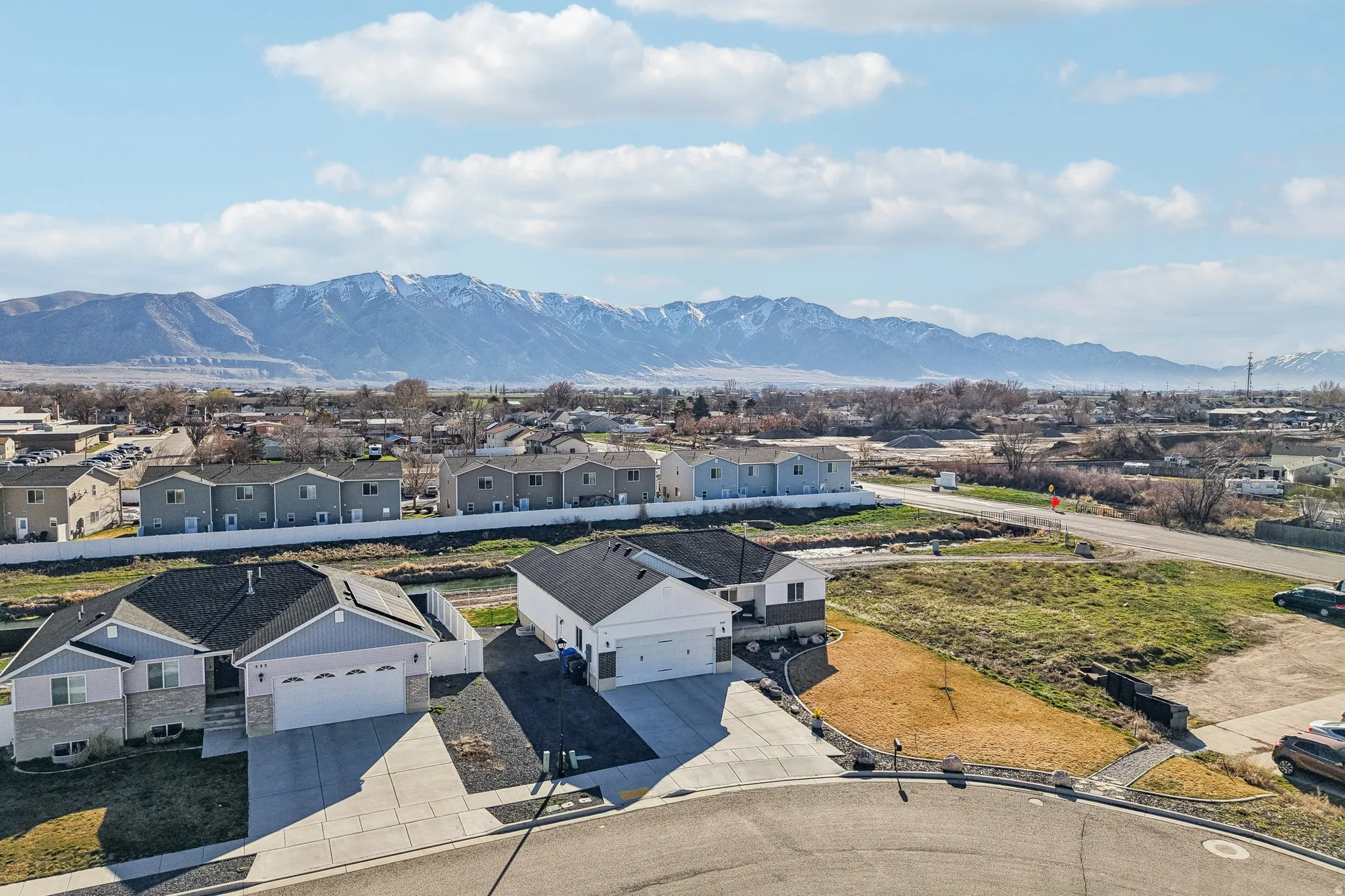 Aerial perspective of suburban area with a mountainous background