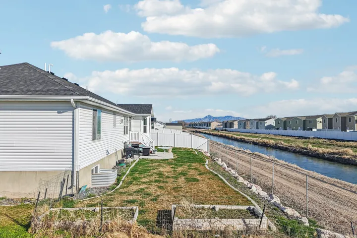 Water view featuring a fenced backyard and nearby suburban area