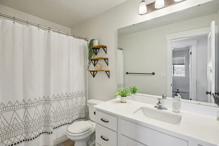 Bathroom with vanity and a shower with shower curtain
