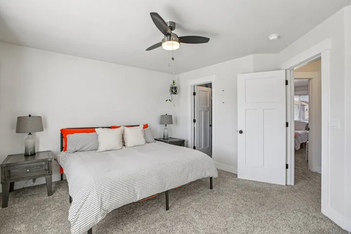 Bedroom featuring light colored carpet and a ceiling fan
