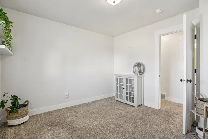 Empty room featuring baseboards and carpet flooring