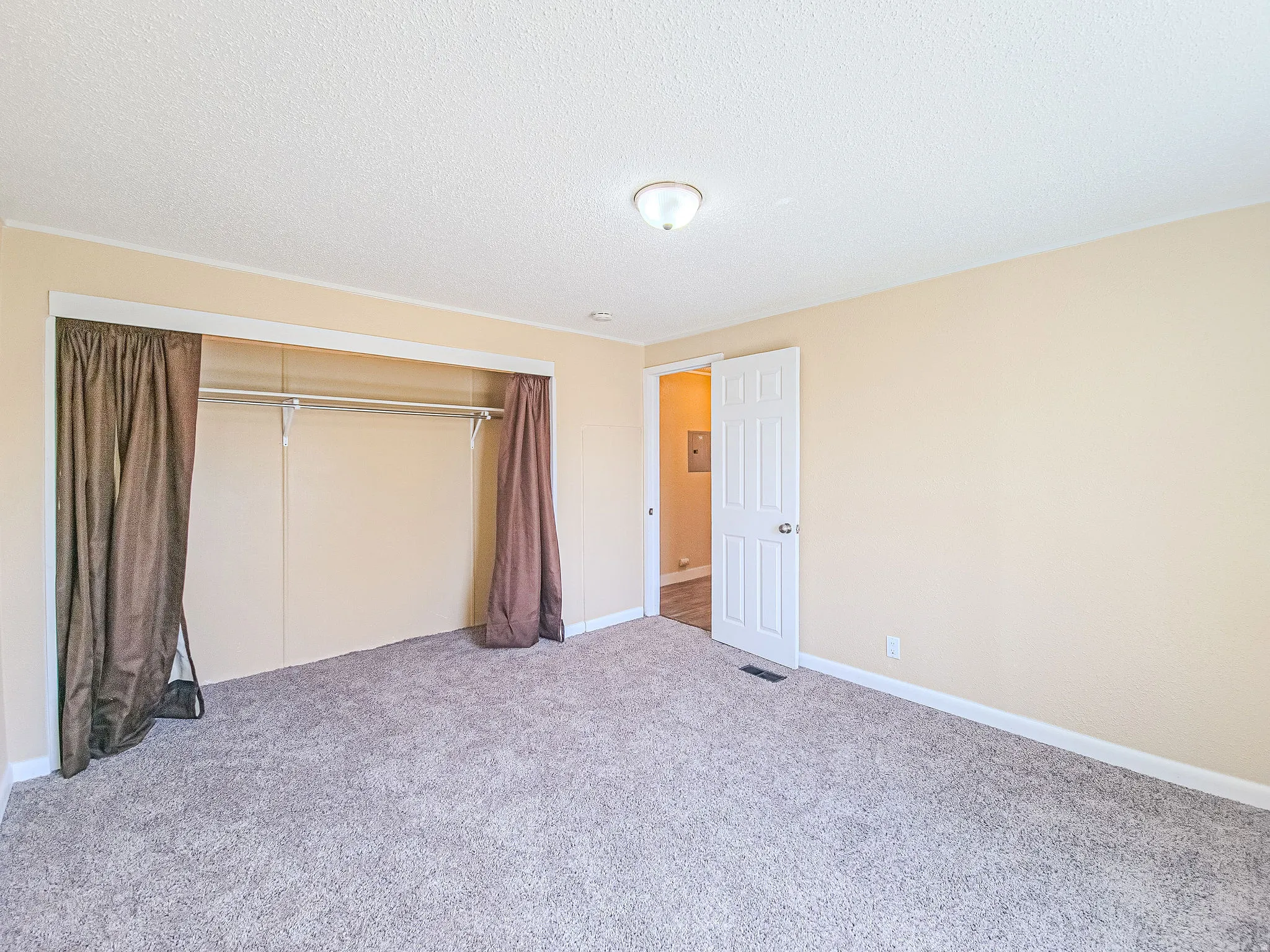 Unfurnished bedroom featuring carpet floors, a closet, and a textured ceiling