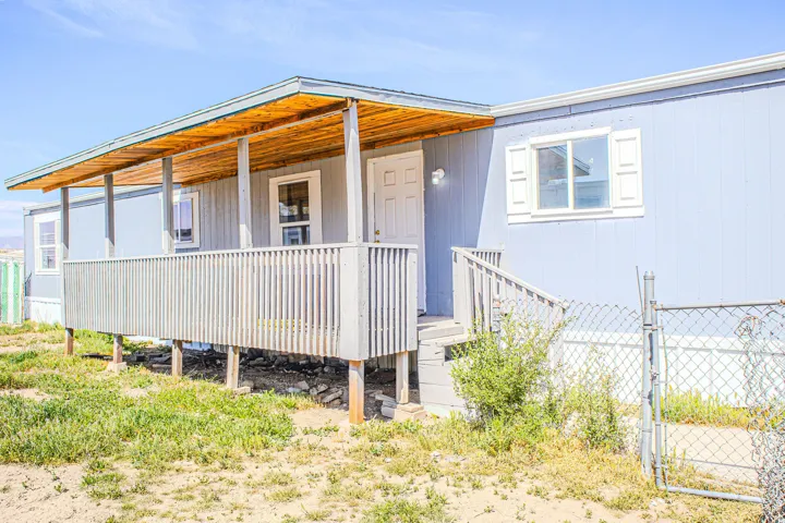 View of front of property featuring a porch and a gate