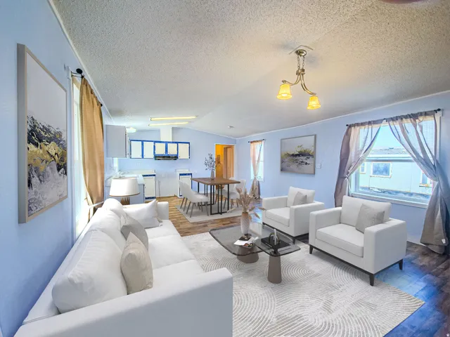 Open-concept living space featuring wood-finish flooring, a contemporary ceiling light fixture, and a kitchen area with upper and lower cabinetry
