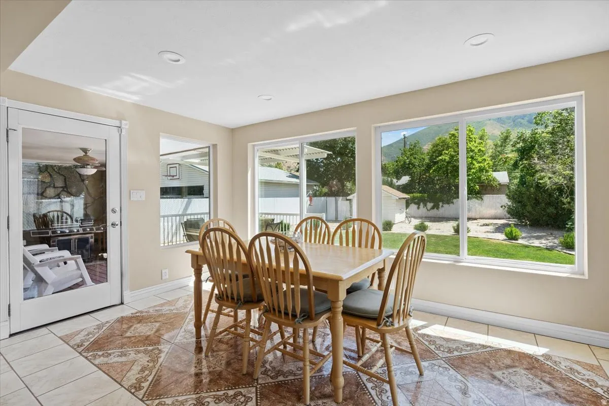 Dining room featuring light tile patterned floors and plenty of natural light