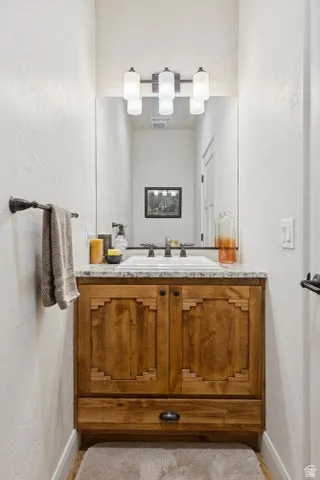 Bathroom with vanity and baseboards