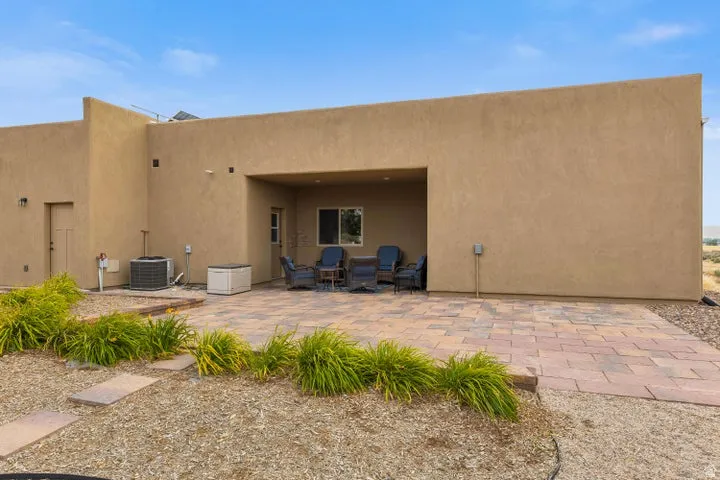 Back of house with a patio and stucco siding