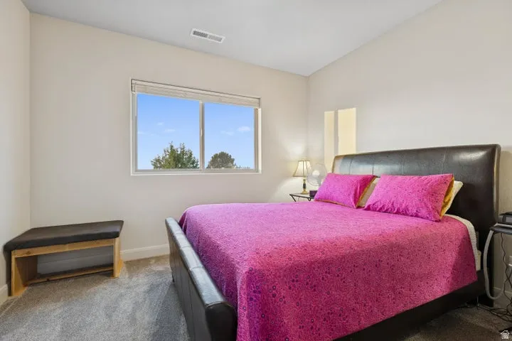 Bedroom with carpet flooring and baseboards