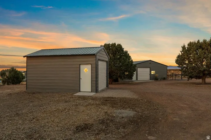 Garage at dusk with a detached garage