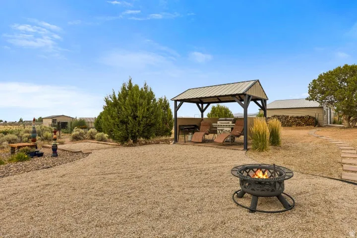 View of yard with a patio area and an outdoor fire pit