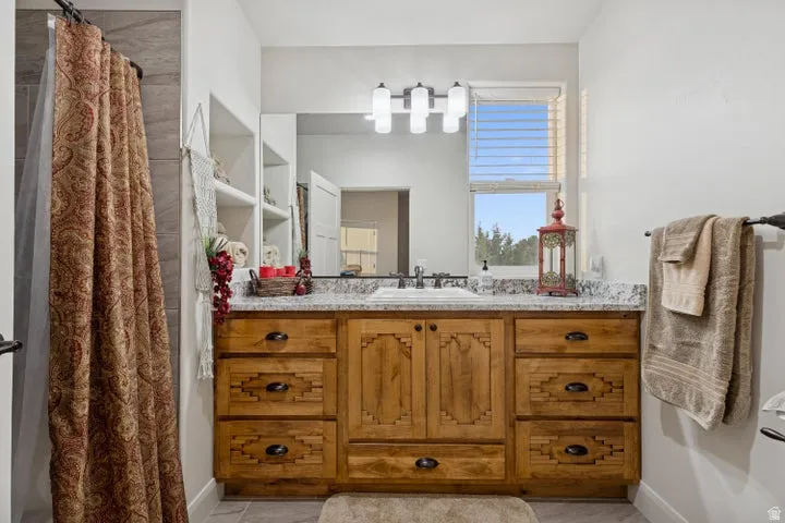 Full bath featuring vanity and a shower with shower curtain