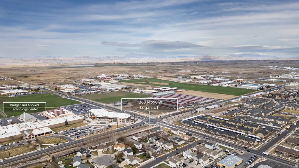 Aerial view of property and surrounding area with industrial structures