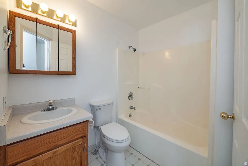 Bathroom featuring vanity and shower / washtub combination