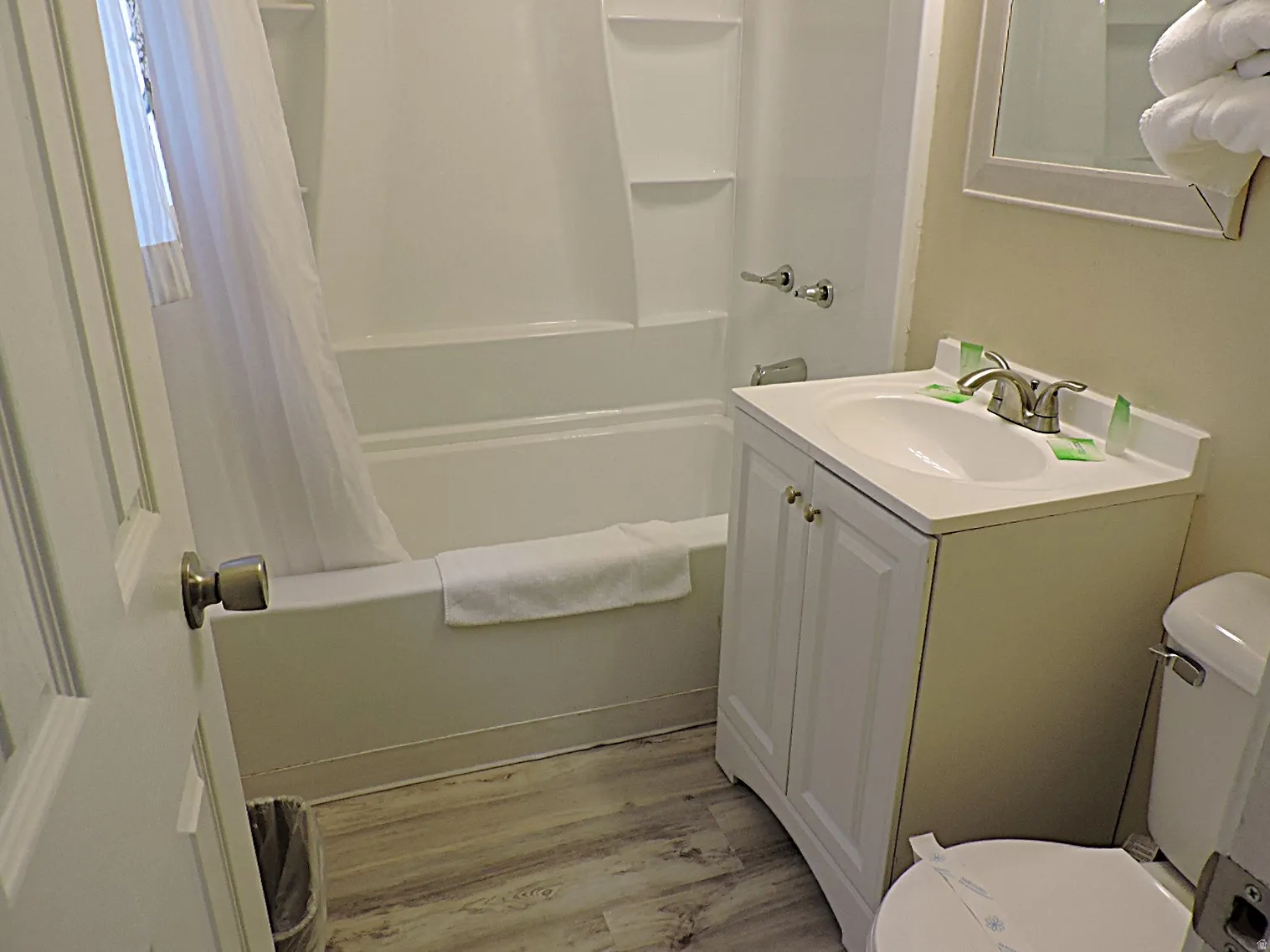 Bathroom with vanity, light wood-style flooring, and shower / tub combo
