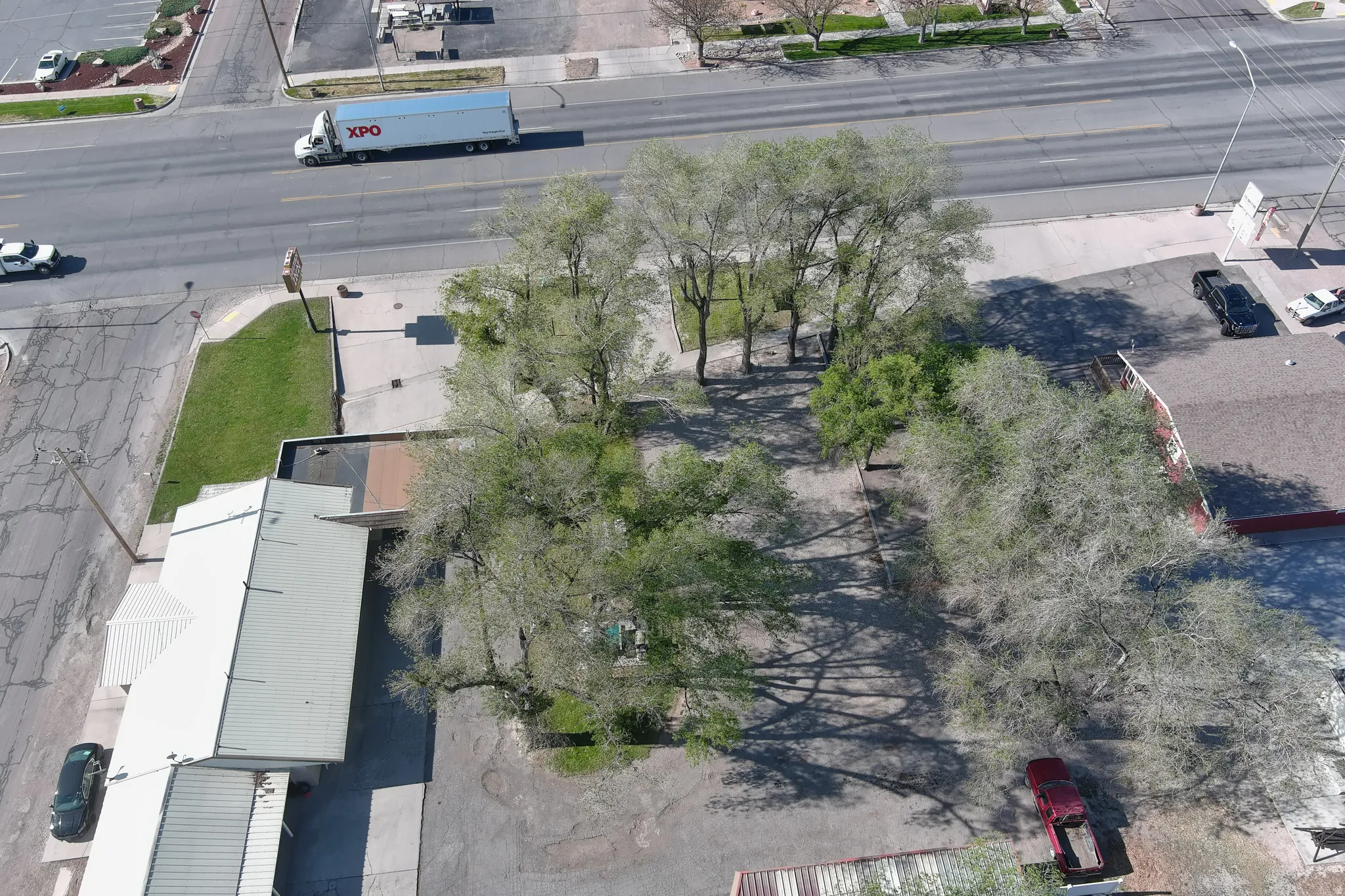 Aerial perspective showcasing a commercial property with extensive paved areas