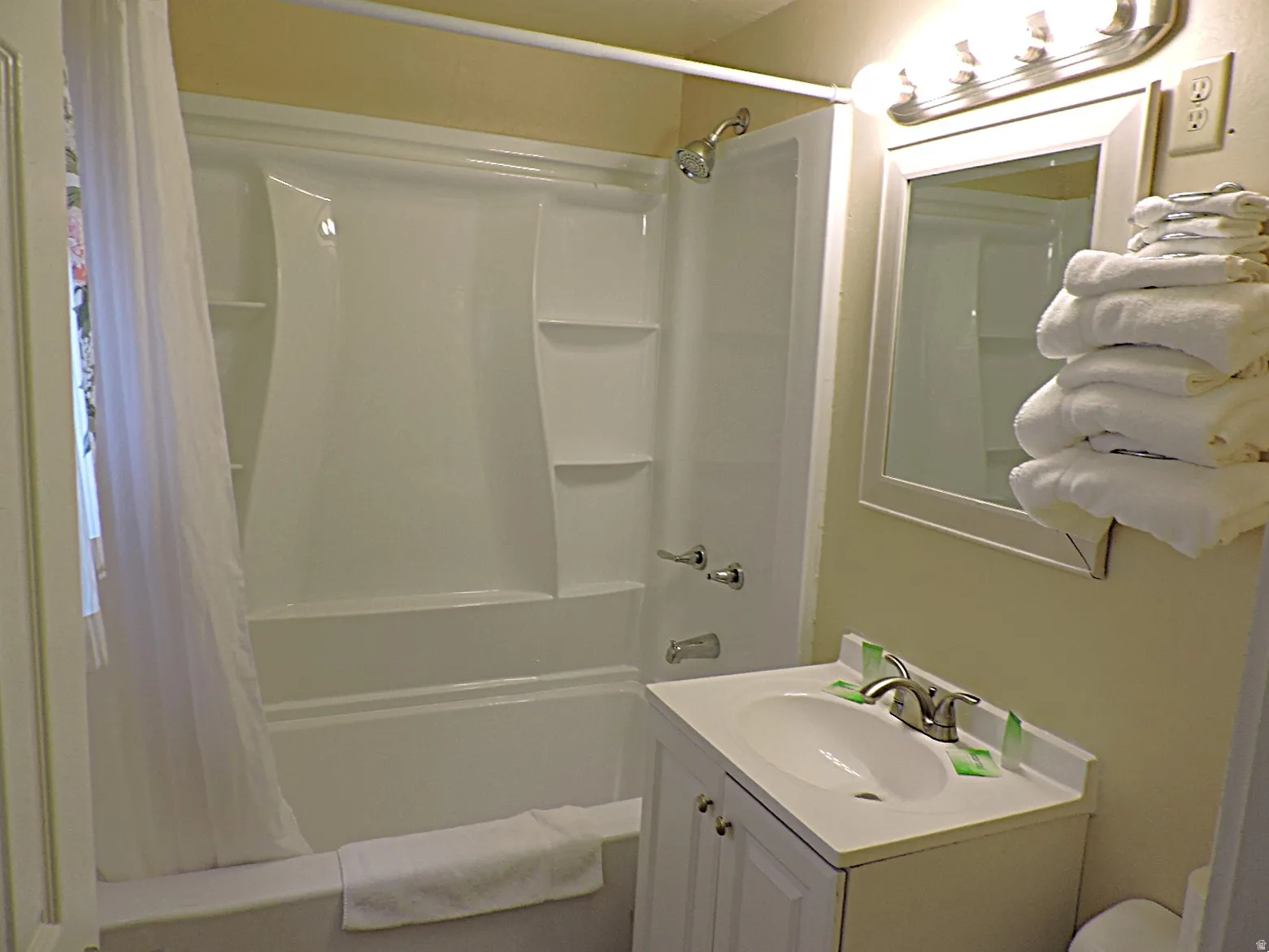 Bathroom with vanity and shower / bath combination with curtain