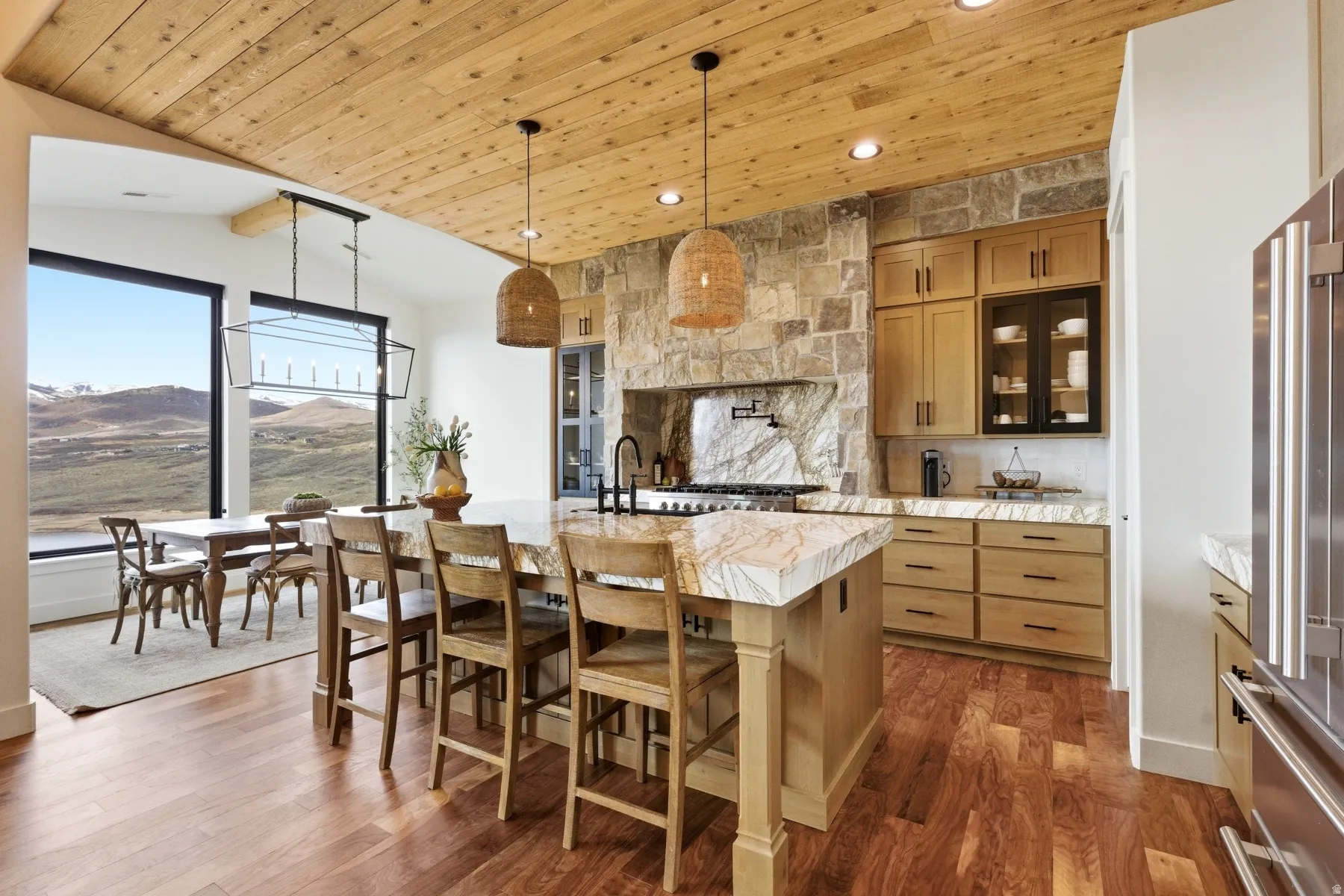 Kitchen featuring a vaulted wood ceiling, glass fronted cabinets, a mountain view, dark wood-style flooring, and pendant lighting