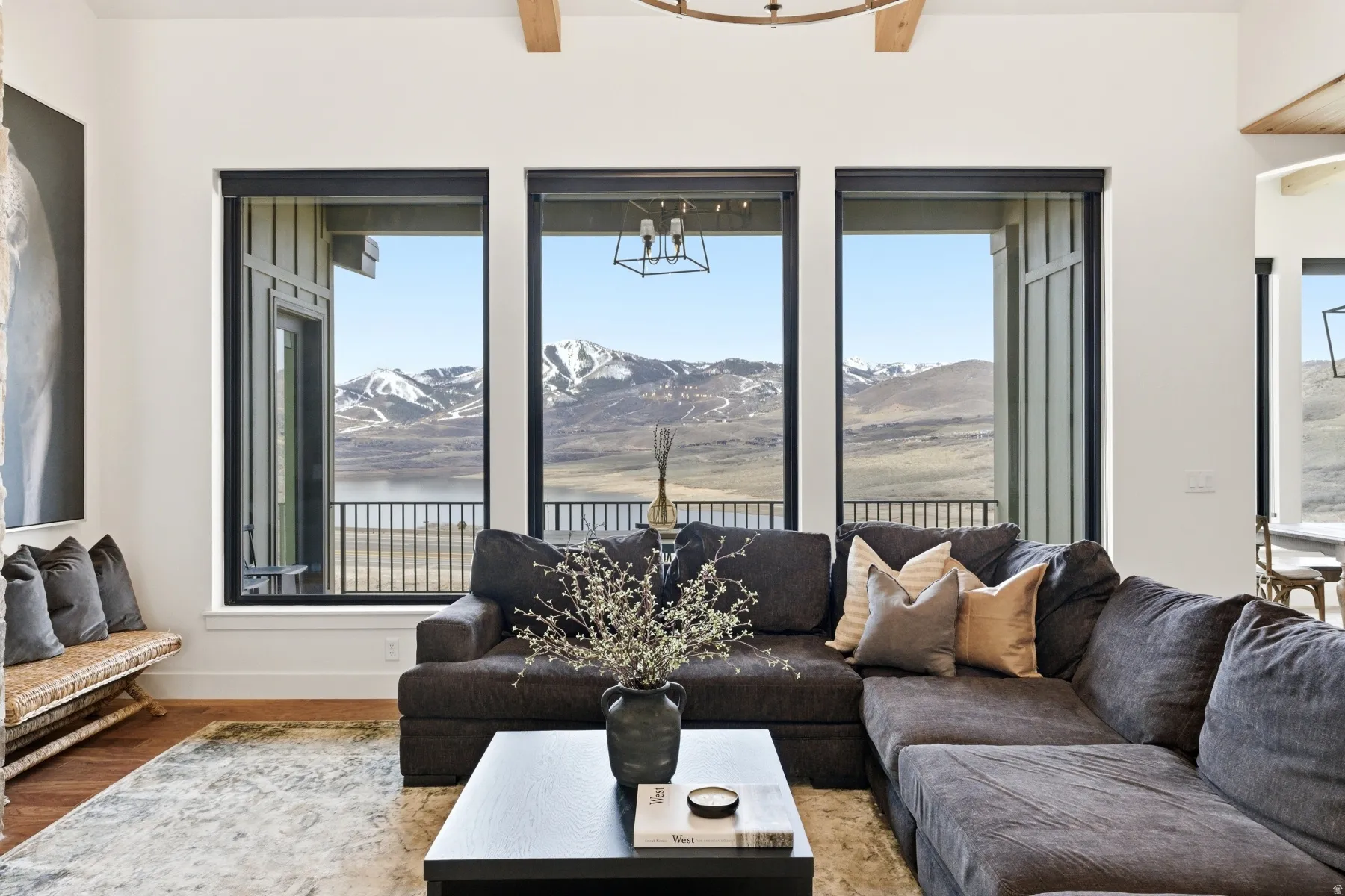 Living area featuring plenty of natural light, a chandelier, and wood finished floors