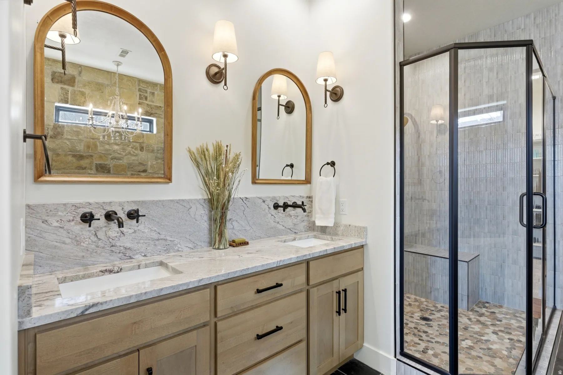 Full bathroom featuring double vanity, a shower stall, and backsplash