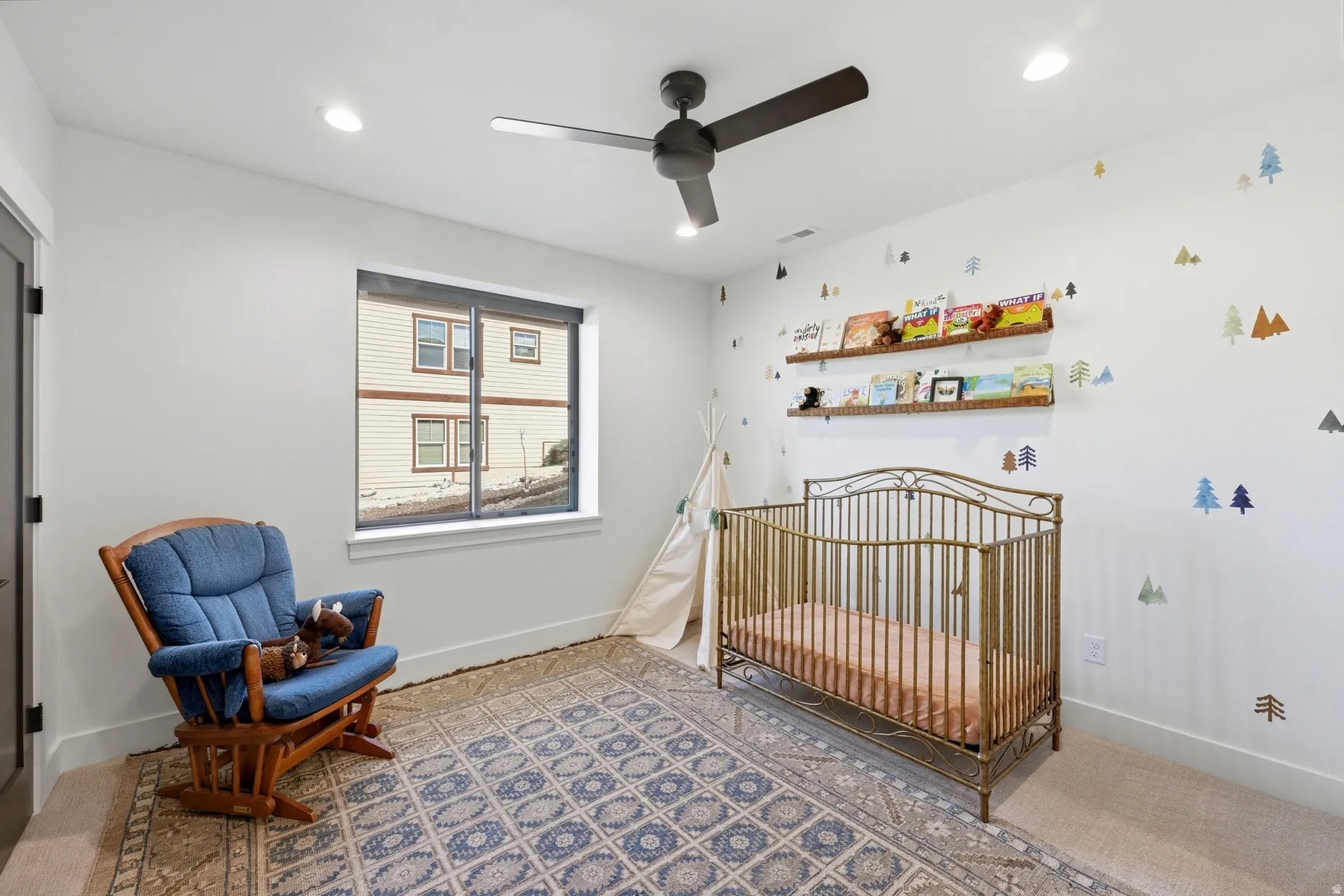 Bedroom with a crib, a ceiling fan, and recessed lighting