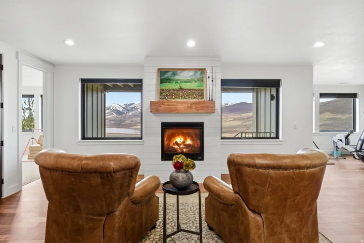 Living area featuring hardwood / wood-style floors, a fireplace, and recessed lighting