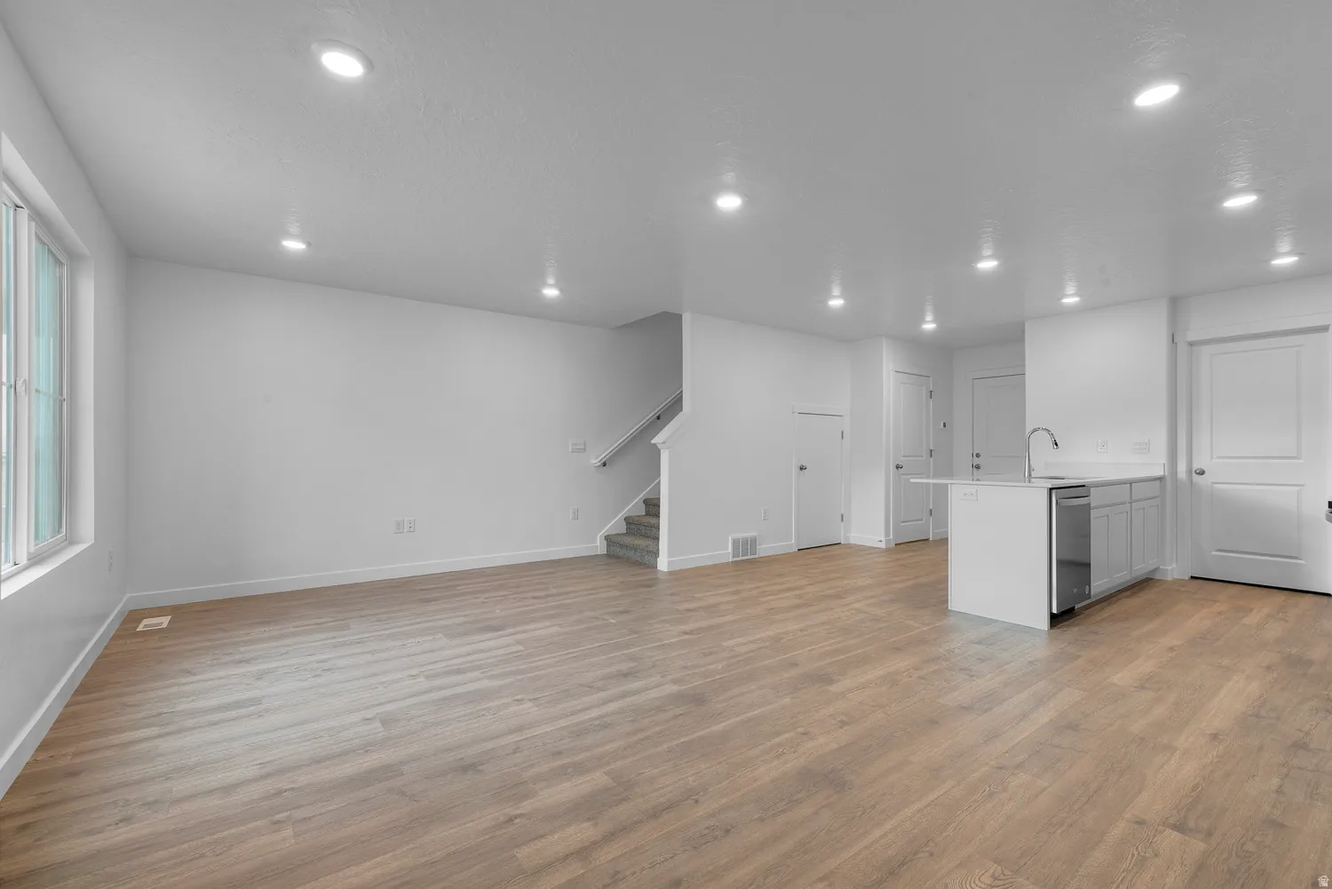 Unfurnished living room featuring light wood-type flooring and recessed lighting