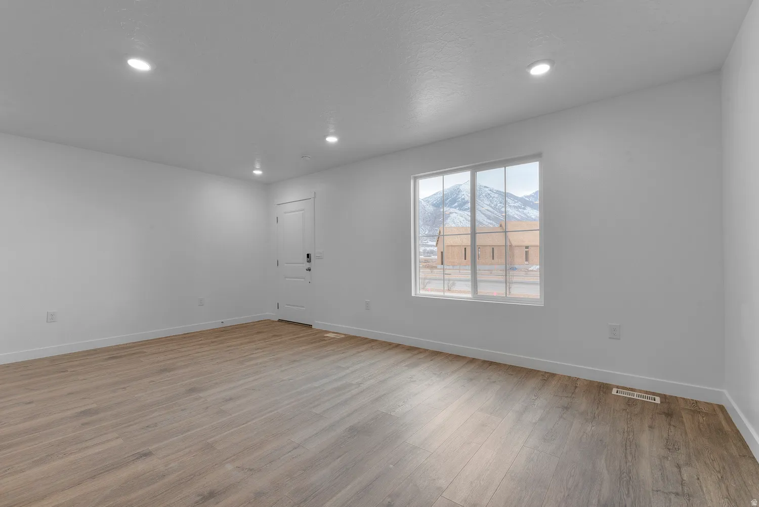 Spare room with light wood-style flooring and recessed lighting