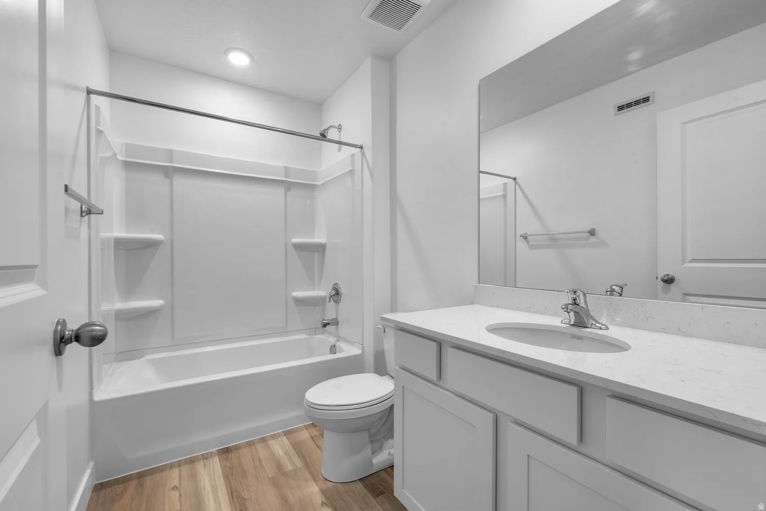 Full bathroom with vanity, light wood finished floors, and shower / bathtub combination
